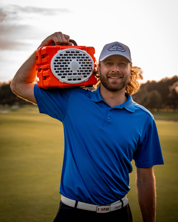 Sean Johnson with his Orange Turtlebox Original on the golf course