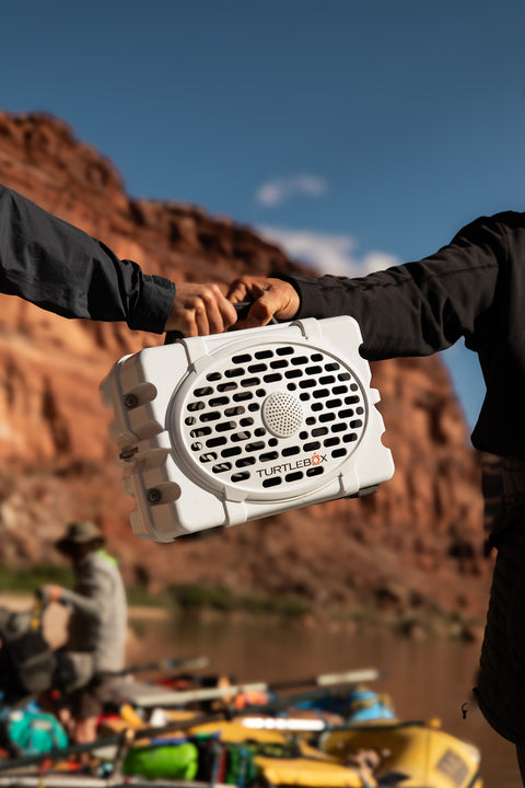 Turtlebox with kayakers on a river bank