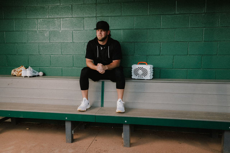MLB Pitcher, A.J. Minter, in the dugout wit his Turtlebox playing music