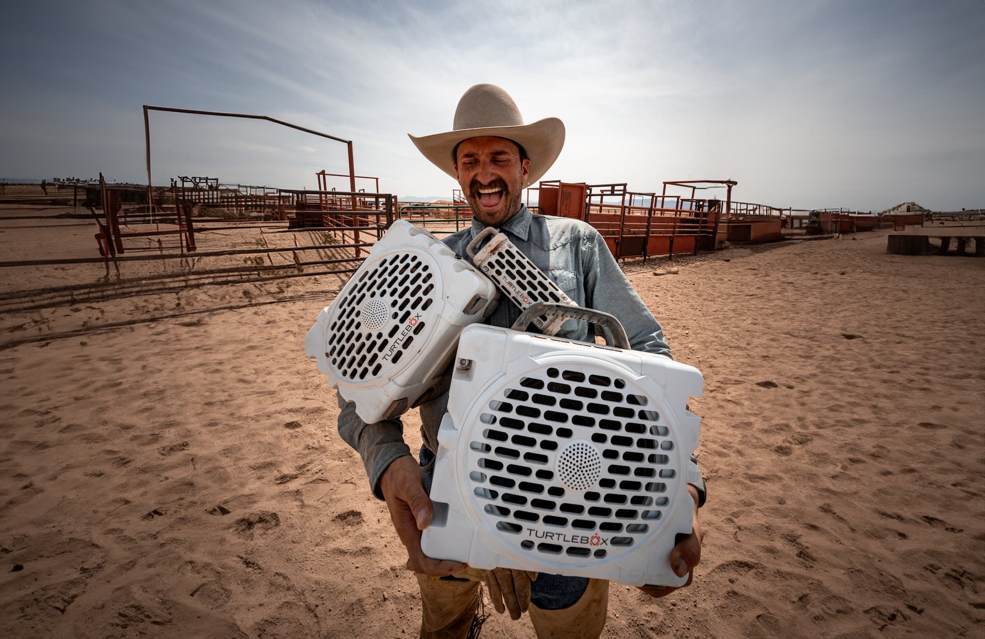 A cowboy holding Original Gen 3, Grande and Ranger on his hands.