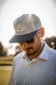 lifestyle photo of a man wearing the all mesh blue cap
