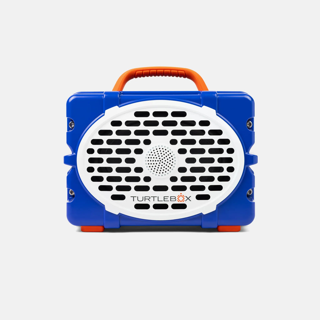 A blue and white portable speaker with an orange handle, branded TURTLEBOX, shown against a light gray background.