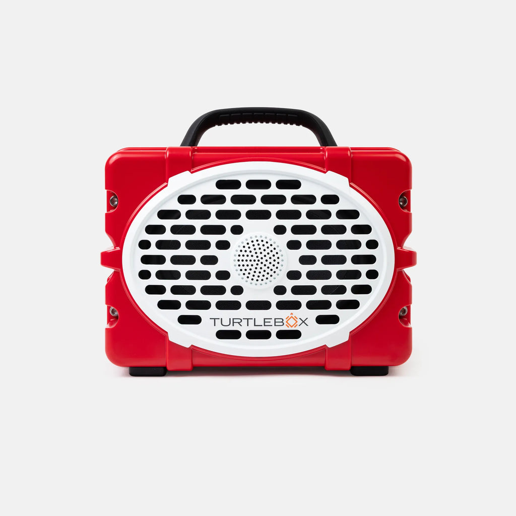 A red and white Turtlebox portable speaker with a black handle, shown against a light gray background.
