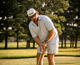 Lifestyle photo showing a man playing golf, wearing the El Camino Hat