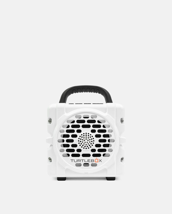 White portable device with a handle on a light gray background, featuring the brand 'TurtleBox'.