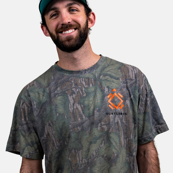 A lifestyle photo showing a guy wearing the Mossy Oak Full Foliage Tee