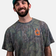 A lifestyle photo showing a guy wearing the Mossy Oak Full Foliage Tee