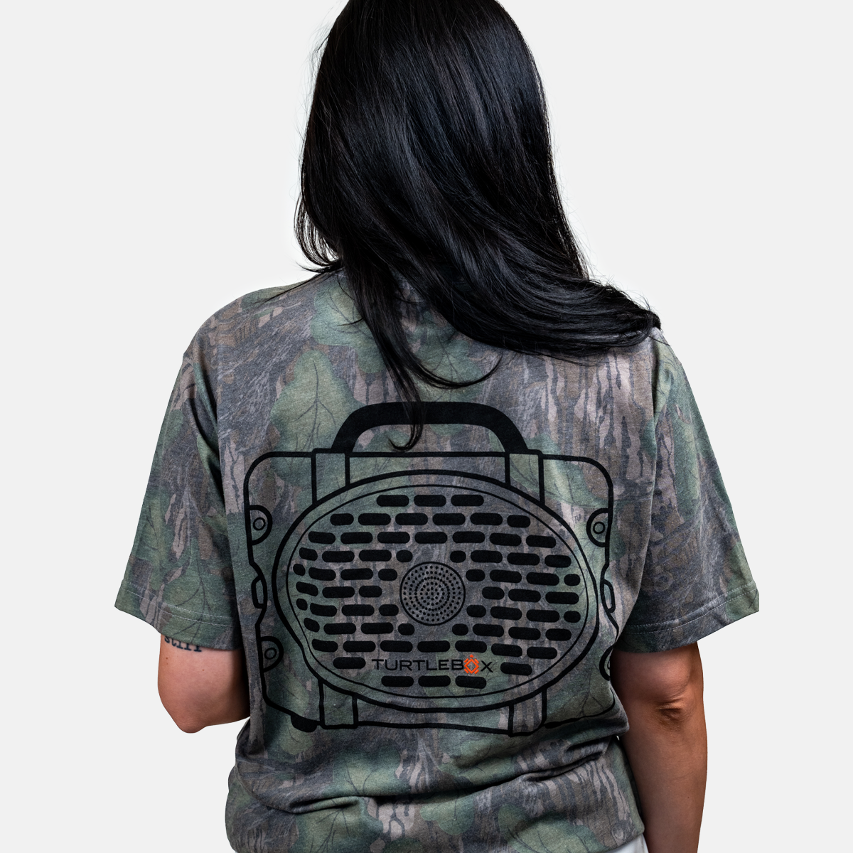 A lifestyle photo showing the back of a girl wearing our Mossy Oak Full Foliage Tee