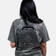 A lifestyle photo showing the back of a girl wearing our Mossy Oak Full Foliage Tee