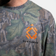 A lifestyle photo showing the Turtlebox logo on the Mossy Oak Full Foliage Tee