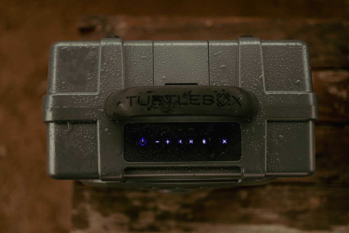 A lifestyle photo showing the top view of Turtlebox Original speaker with water drops on top to show the speaker waterproof. #speaker-color_gray
