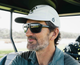 A lifestyle photo of a man with sunglasses wearing the Turtlebox Golfin Turtle Hat