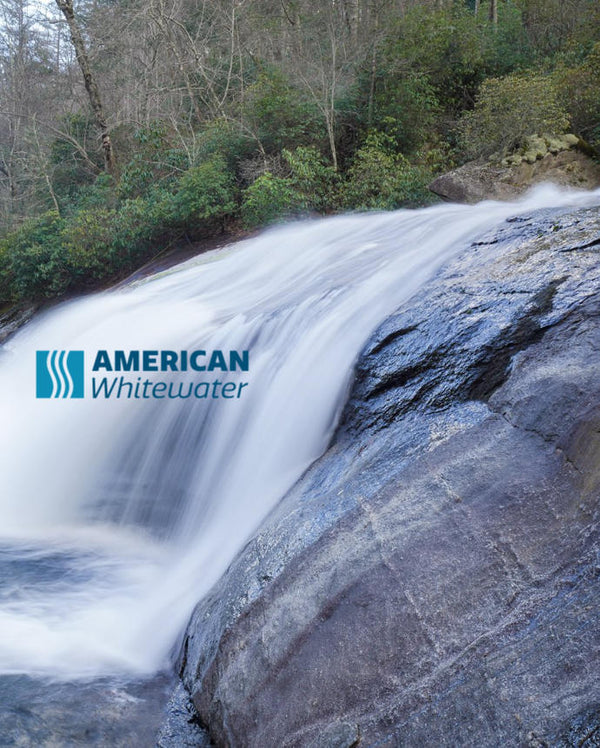 White waterfall over rocks with tress in the background showing American Whitewater logo.