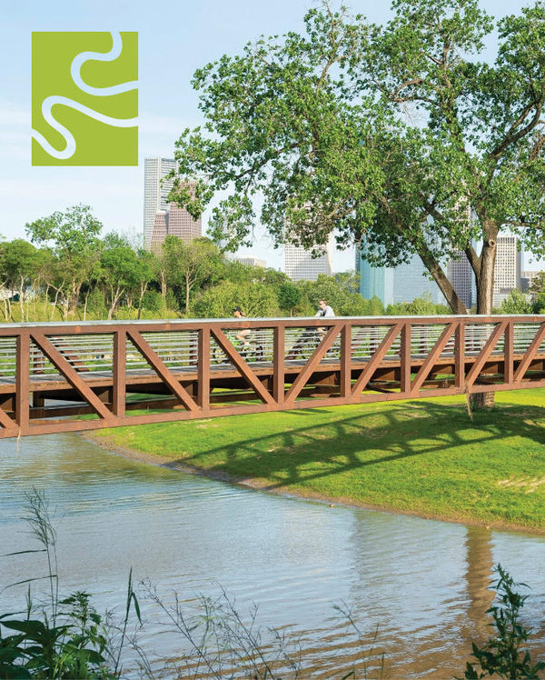 People biking over a bayou bridge with skyline in background showing the Buffalo Bayou Conservation logo.
