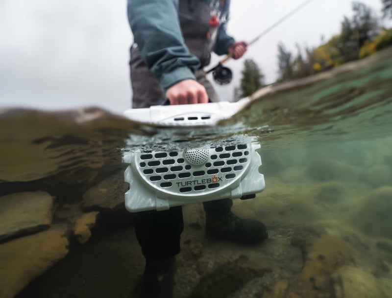 Fisherman put his Turtlebox under water.
