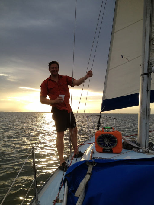 A founder in a boat with Turtlebox v1 in orange