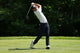lifestyle photo of a man golfing, wearing a Live Free Patch Blue Hat