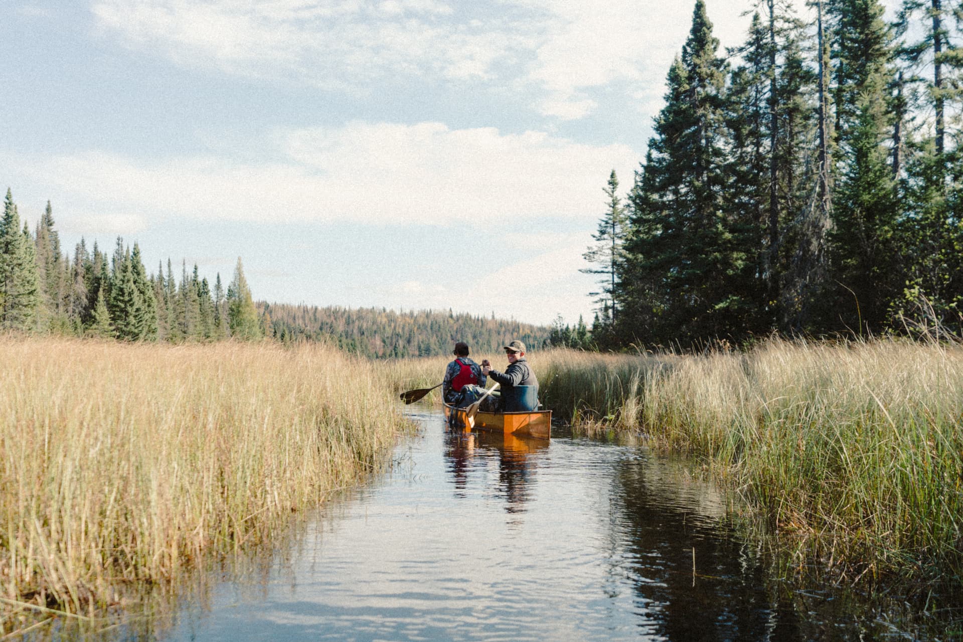 A lifestyle photo from two guys rowing a boat on boundary waters.