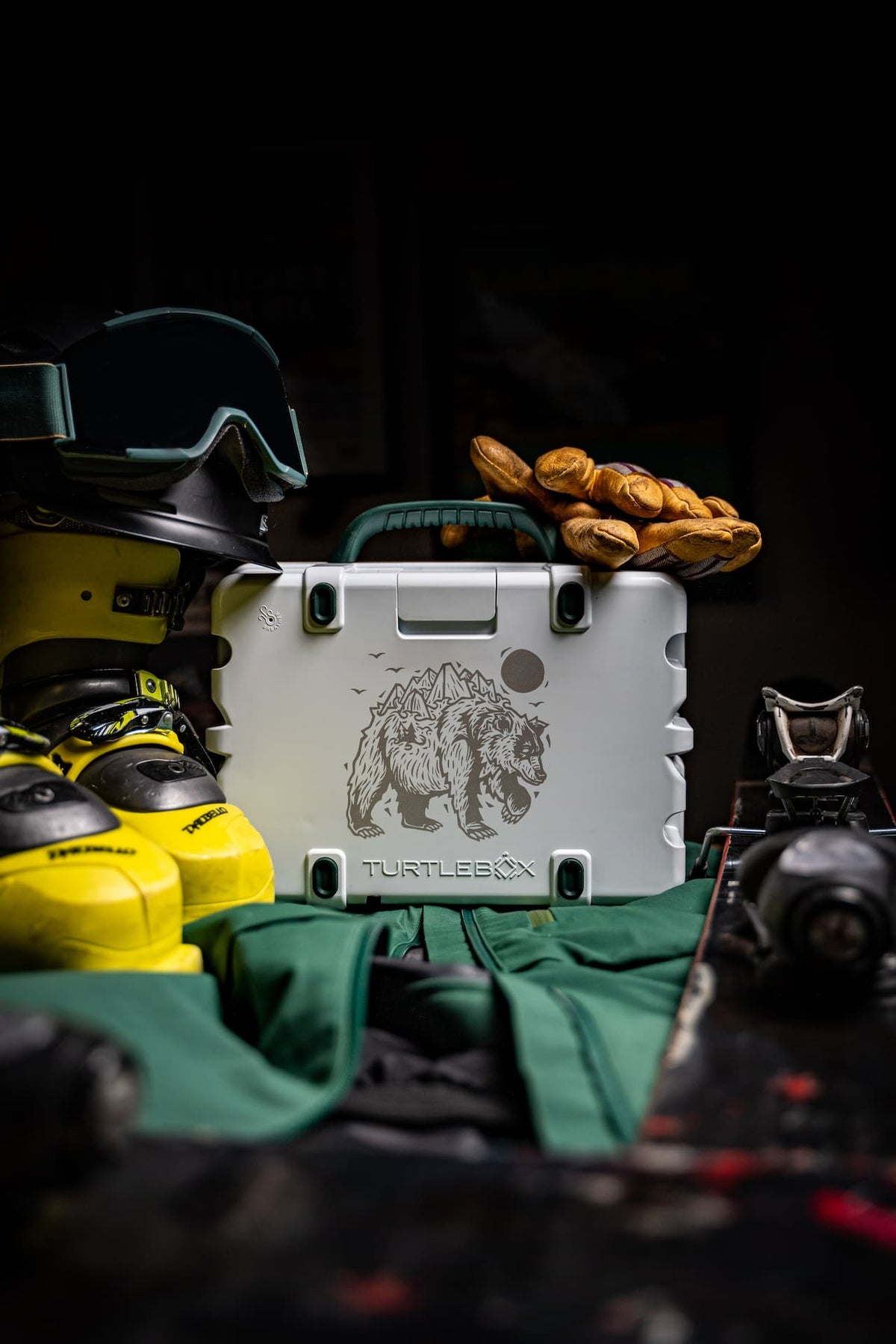A lifestyle photo of the Turtlebox Mountain Bear Artist Series edition with boots and gloves on the scenario #speaker-color_mountain-bear-artist-series