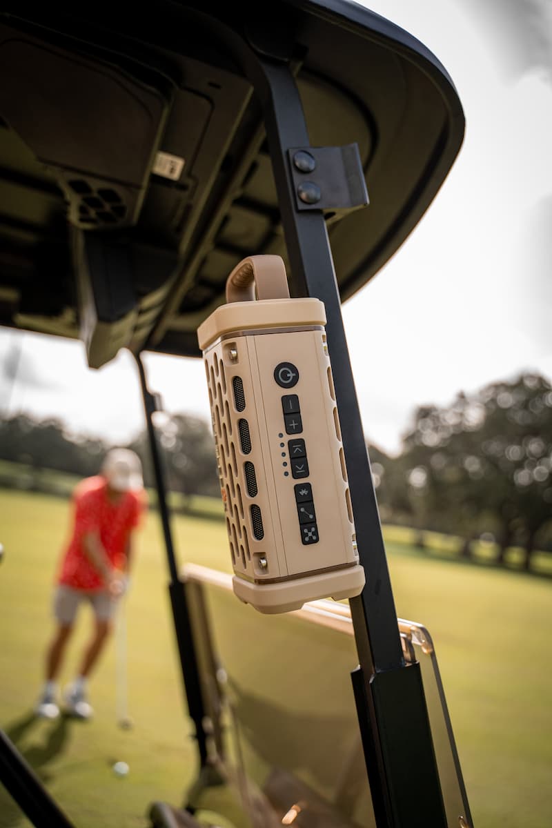 lifestyle photo of a Tan Ranger speaker mounted on a golf cart #base-color_tan