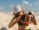 Lifestyle photo of a woman on the beach wearing the Turtle Mountain Gray Hat