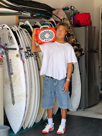 Kyan Yang with a Turtlebox speaker and surf boards on the back