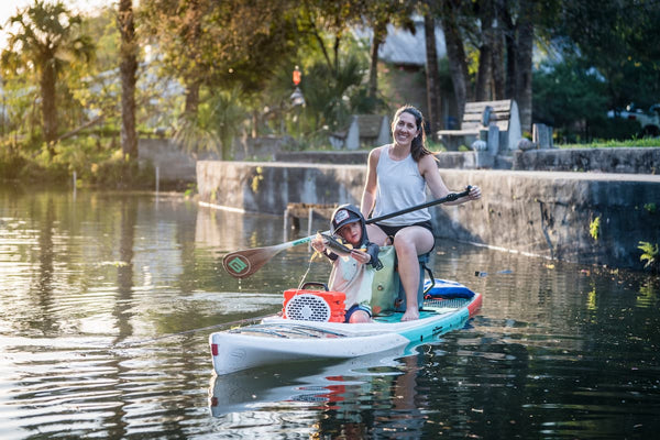 A mother with his child on a kayak in a lake