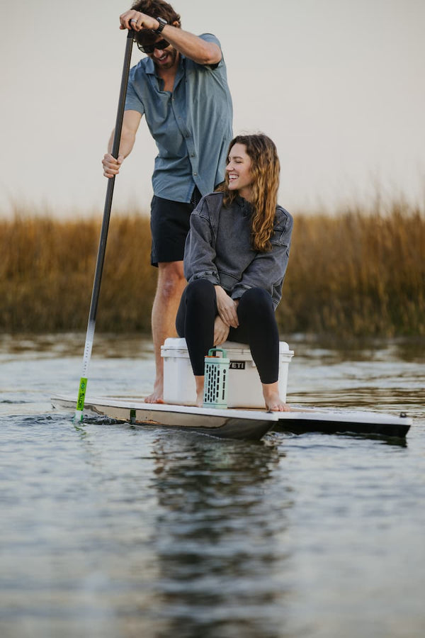 A couple doing paddle in a lake