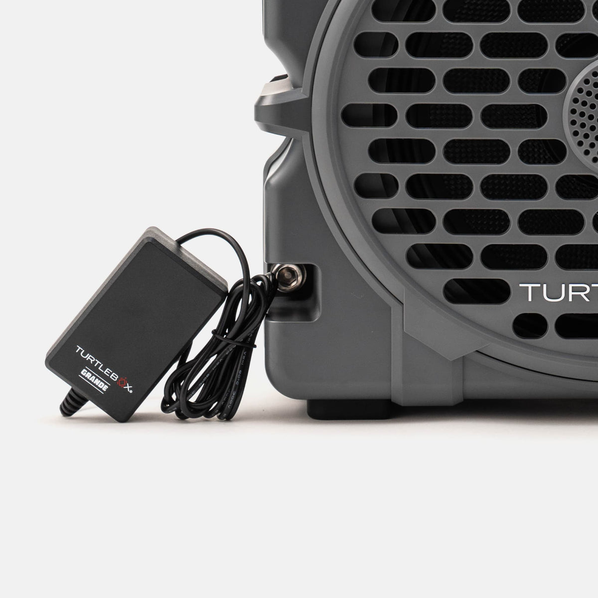 A lifestyle image of a grande charger on a white background