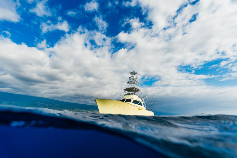 Boat on the ocean with a partly cloudy sky