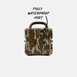 A rugged hard-shell case with a brown, beige, and black camouflage pattern, featuring a top handle and a metal port cover. Handwritten text above reads 'FULLY WATERPROOF PORT' with an arrow pointing to the metal port on the front.