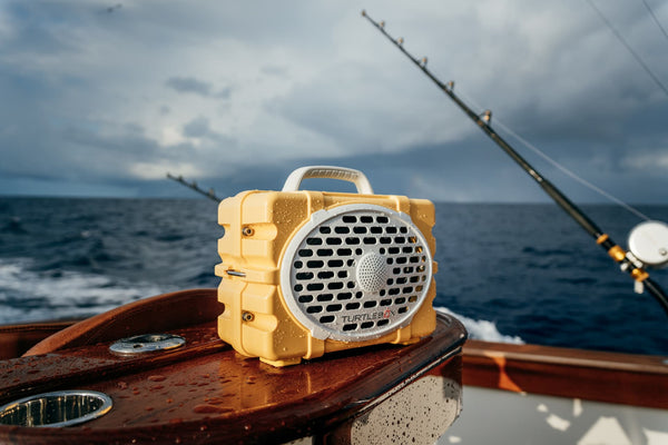 Yellow speaker on a boat with ocean and cloudy sky in the background