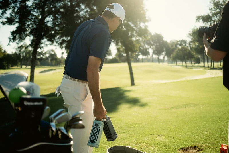Golfer Scottie Scheffler preparing to hit a golf ball on a golf course