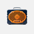 A Turtlebox portable speaker in navy blue and bright orange, featuring a front-facing oval speaker grille with the brand name printed in white, a top carrying handle, and side lugs, shown against a light gray background.
