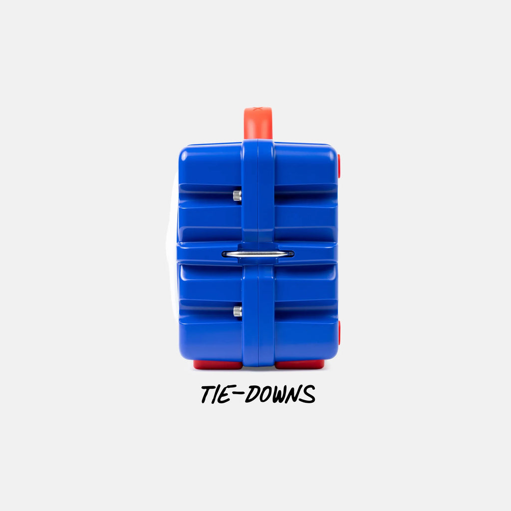 A blue plastic luggage tag-style organizer with red accents and a white side panel, shown from the back on a light gray background with the text 'TIE-DOWNS' underneath.