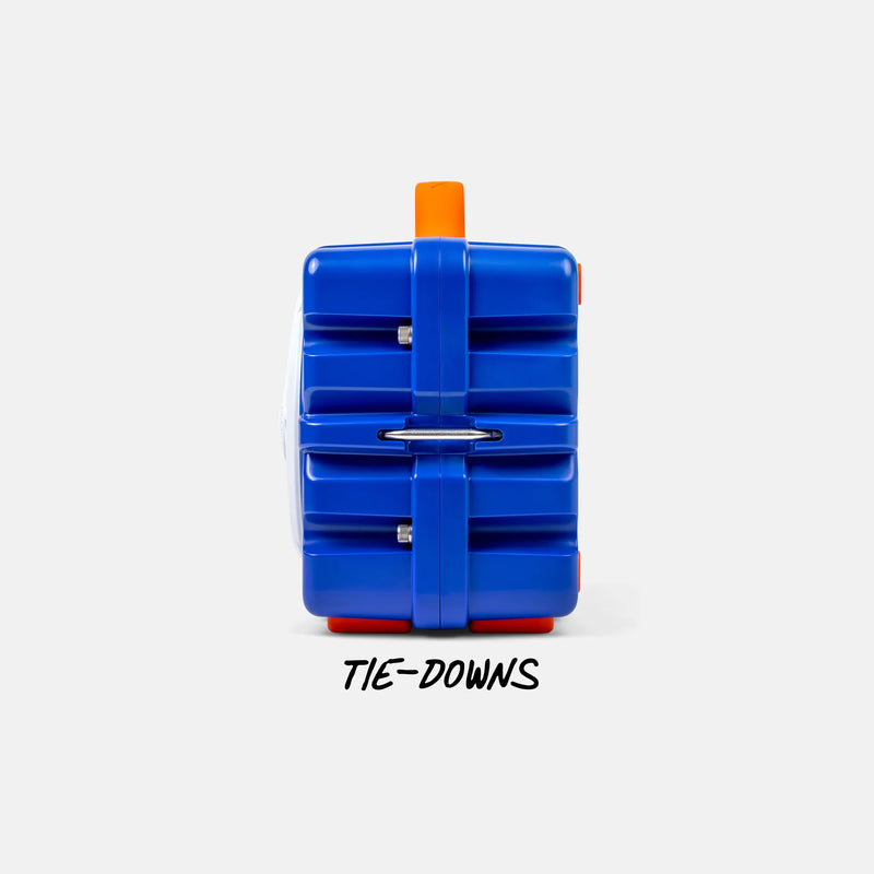 A blue plastic puzzle cube with orange and red accents, shown from the back with the text 'TIE-DOWNS' printed below it on a light gray background.