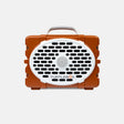 An orange and white TurtleBox portable speaker with a carrying handle, shown against a light gray background.