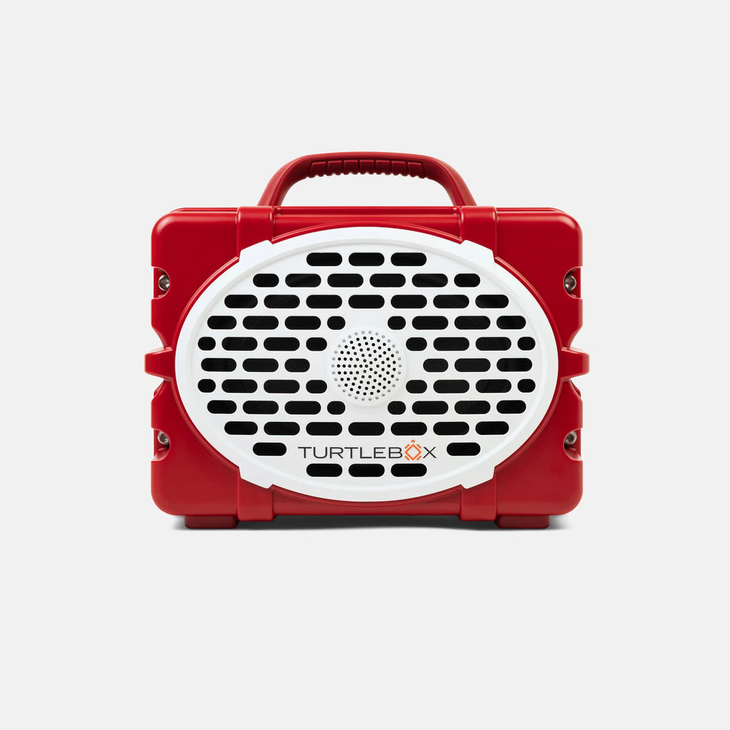 A red and white TurtleBox portable speaker with a handle on top, shown against a light gray background.