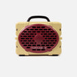 A retro-style portable speaker by Turtles X, featuring a cream-colored body, a prominent dark red oval front grille, and a black carrying handle, shown against a light gray background.