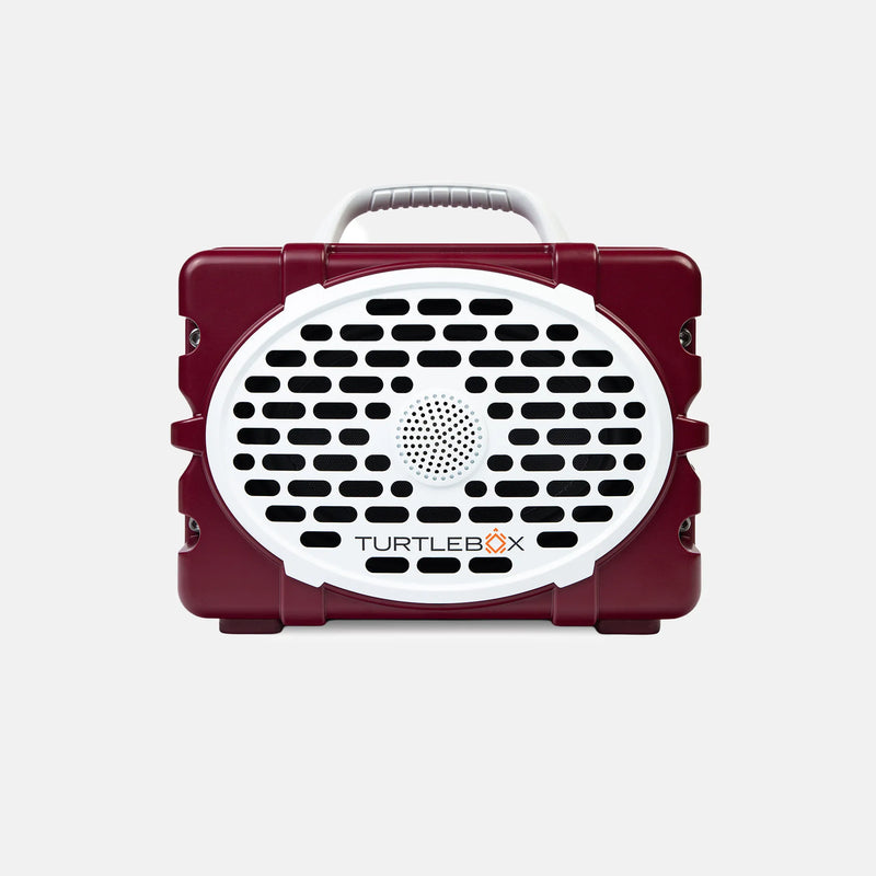 A maroon and white TurtleBox portable speaker with a carrying handle, shown against a light gray background.