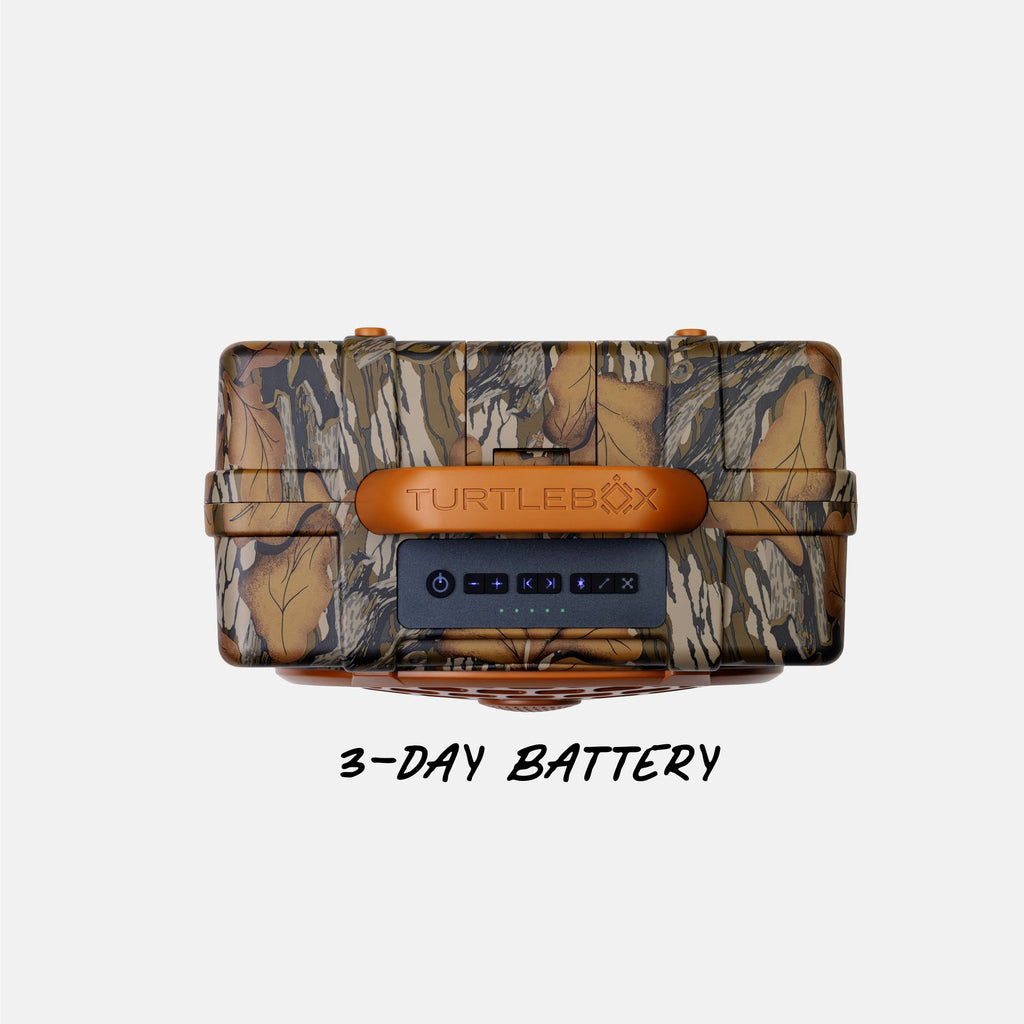 A Turtlebox hard case with a brown and beige leaf-and-branch camouflage pattern, featuring a tan handle and a black front control panel. The text '3-DAY BATTERY' is written below the case on a light gray background.
