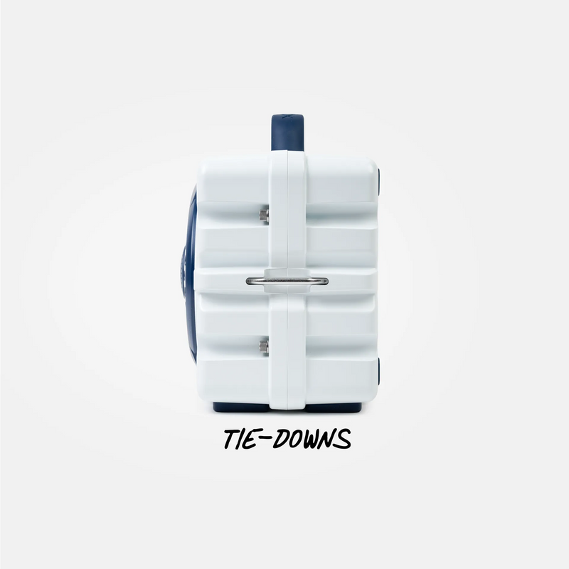 A white hard-sided suitcase with navy blue accents, shown from the back with a metal ring handle and the text 'TIE-DOWNS' printed below on a light gray background.