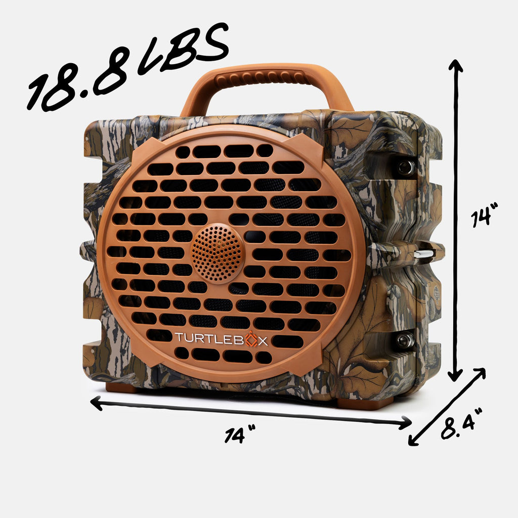 TurtleBox portable speaker in a camouflage pattern with a brown handle and front grille, shown with black dimension lines and text indicating 18.8 lbs, 14" height, 24" width, and 8.