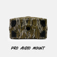 A rugged rectangular audio mount with a green, brown, and beige tiger-stripe camouflage pattern and black rubber feet, shown against a light gray background with the text 'PRO AUDIO MOUNT' below.