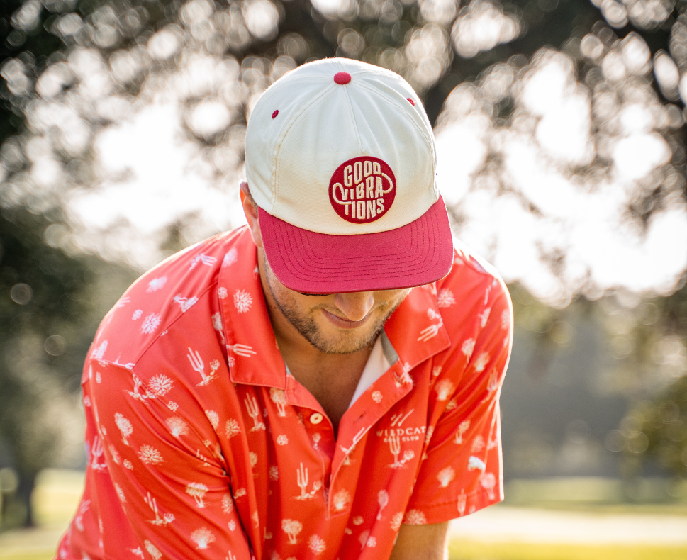 Lifestyle photo of a man with a bright shirt wearing the Good Vibrations Hat