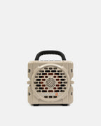 Beige portable speaker with a handle on a white background