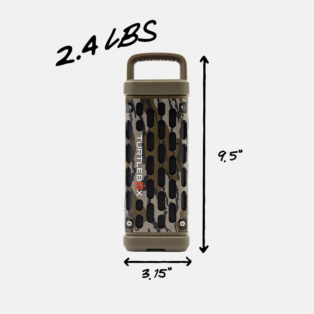 A portable cylindrical speaker with a camouflage pattern and black vent holes, shown with dimension lines indicating 9.5 inches tall, 3.