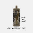 A cylindrical waterproof device with a camouflage pattern and tan top loop, shown on a light gray background with text reading 'DOES NOT FLOAT' and 'FULLY WATERPROOF PORT'.