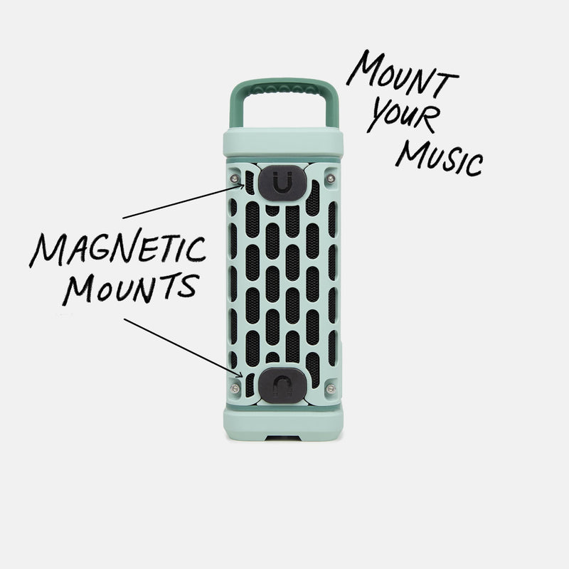 Studio shot of a River Rock Ranger speaker calling out Mount your Music and showcasing the magnetic mounts.  #base-color_river-rock