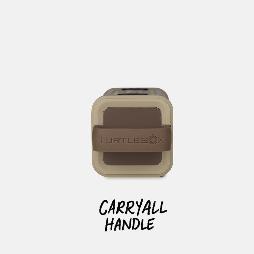 Studio top shot of a Tan Ranger speaker with a label that says Carryall Handle #base-color_tan